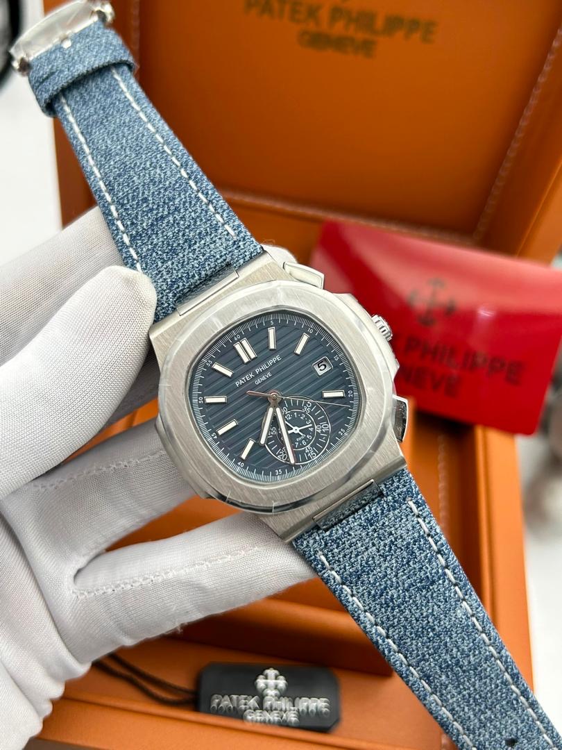 Silver luxury wristwatch with blue fabric strap