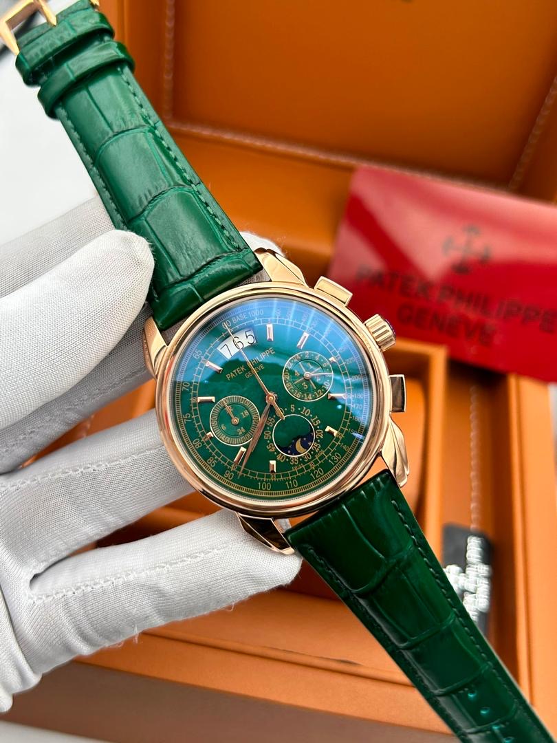 Gold luxury wristwatch with an emerald green dial and strap